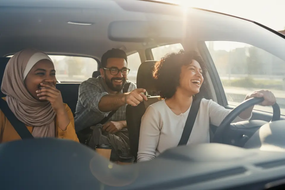 Coworkers sharing a laugh in a car